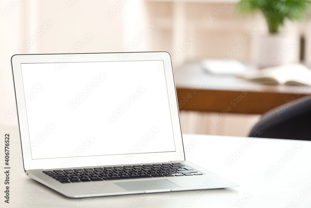 New modern laptop on white table in office. Space for text New modern laptop on white table in office. Space for text