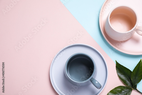 Beautiful table setting with green leaves on color background, flat lay. Space for text