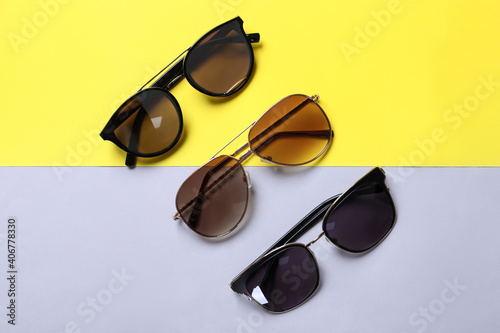 Stylish sunglasses on color background, flat lay
