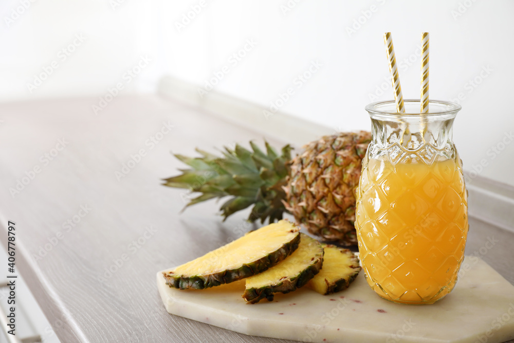 Delicious pineapple juice and fresh fruit on wooden table, space for text Delicious pineapple juice and fresh fruit on wooden table, space for text