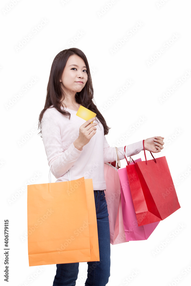 Portrait of young female holding credit card,withshopping bags Portrait of young female holding credit card,withshopping bags