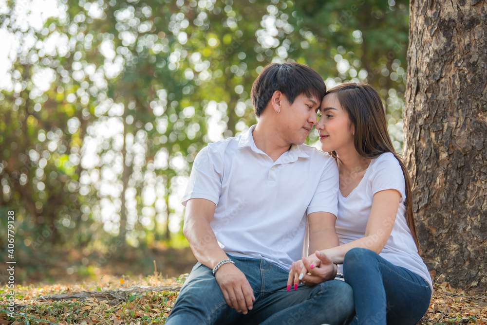 Portrait of young asian couple in love in the forest,Thailand people happy to be together,Valentine day concept Portrait of young asian couple in love in the forest,Thailand people happy to be together,Valentine day concept