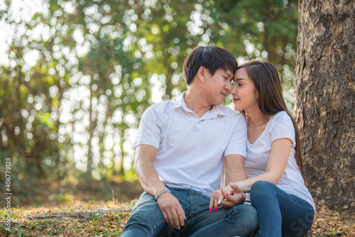 Portrait of young asian couple in love in the forest,Thailand people happy to be together,Valentine day concept