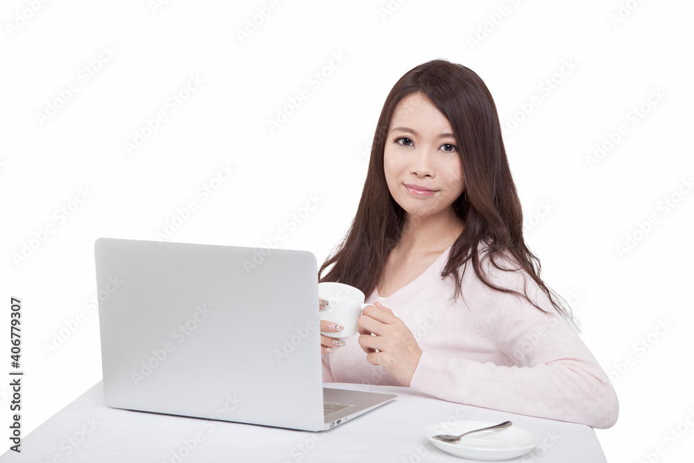 Portrait of young sitting in front of laptop holding coffee cup Portrait of young sitting in front of laptop holding coffee cup