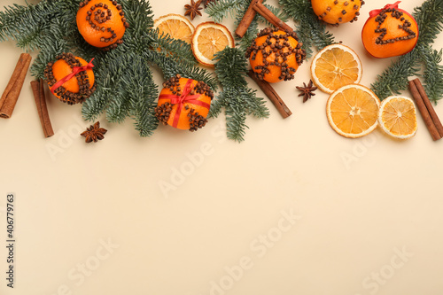 Flat lay composition with pomander balls made of fresh tangerines on beige background. Space for text photo