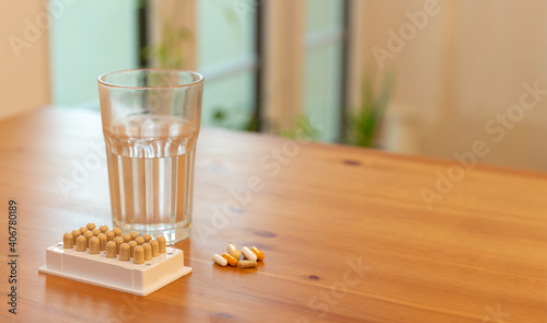 Nutritional supplement pills and glass of water