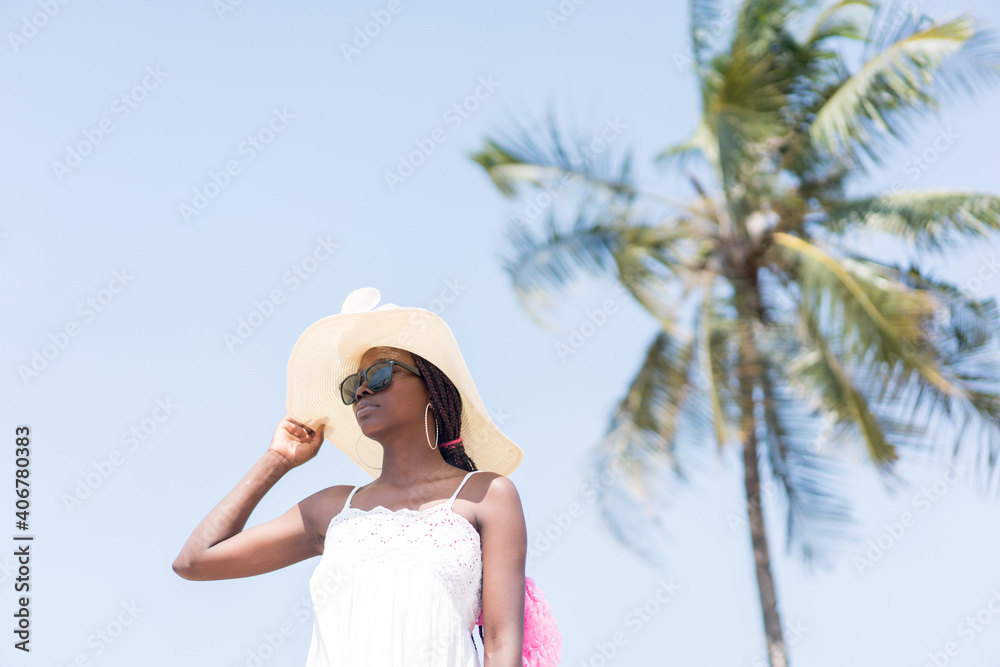 Beautiful young black African American woman on the tropical beach