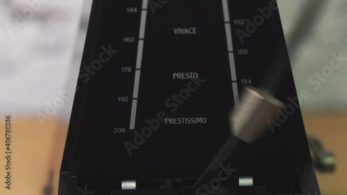 Antique metronome with pendulum in slow motion. Vintage wooden classic style. Equipment of music, beat, rhythm mechanism. 4K 25fps Video Footage.