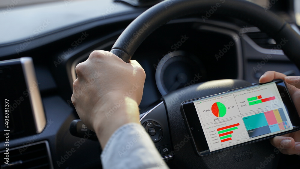 Business man driving and analysing graph visualization report on mobile 