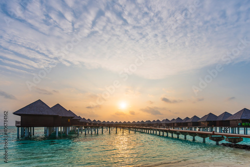 The rising sun over Maldivian stilt houses.