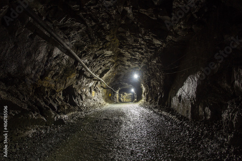 Underground gold mine shaft tunnel drift with light © Mishainik