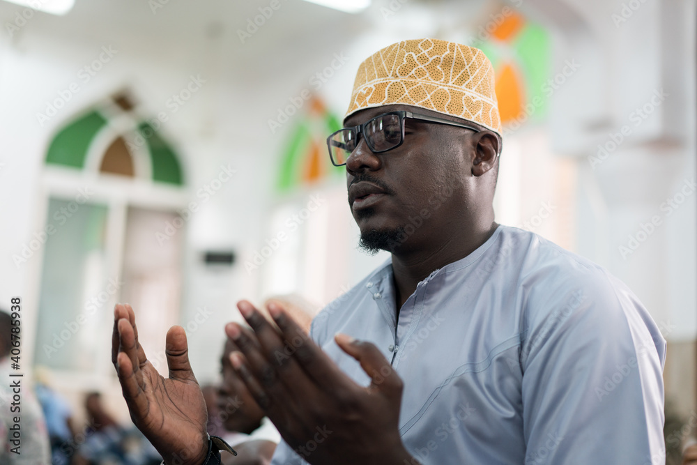 Black Muslim adult man praying inside mosque on Friday Black Muslim adult man praying inside mosque on Friday