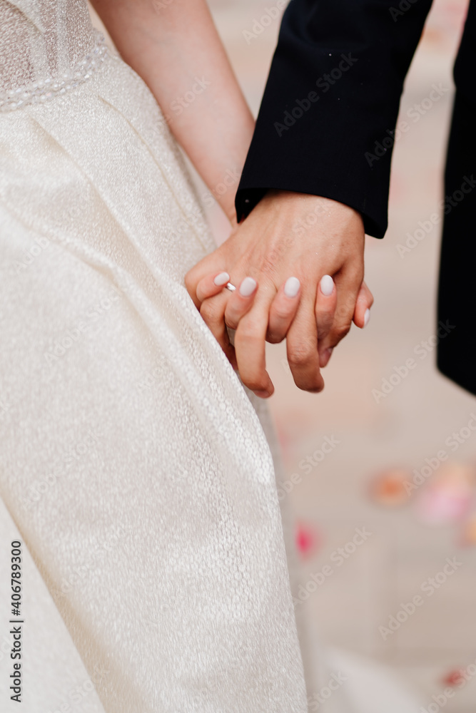 close up. newlyweds hold hands. happy bride and groom. close up. newlyweds hold hands. happy bride and groom.