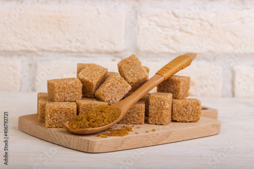 Reed Sahao in cubes on a wooden board and a spoonful of sugar with sand