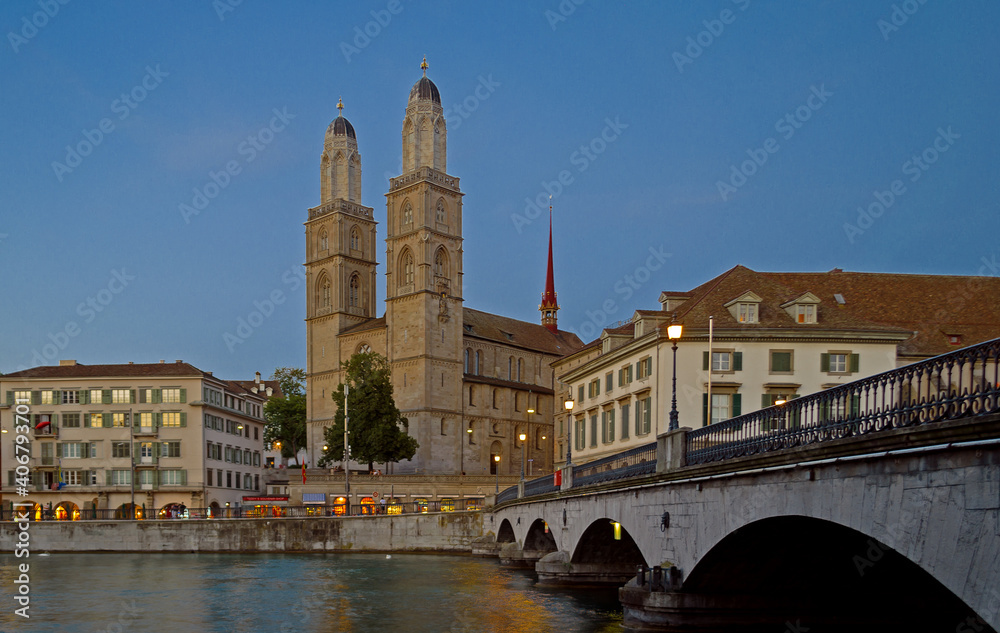 Iconic view of the Romanesque Grossmunster church in Zurich, Switzerland at night