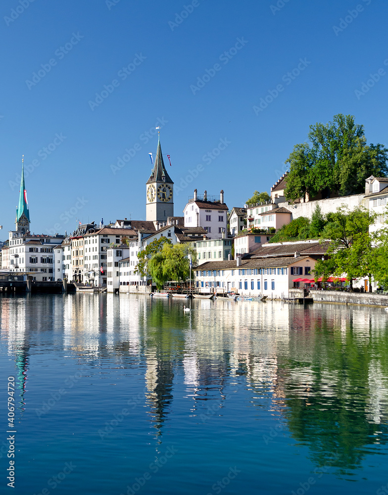 Limnat River Cityview in Zurich, Switzerland showing the  Church of St Peter spire in Summer