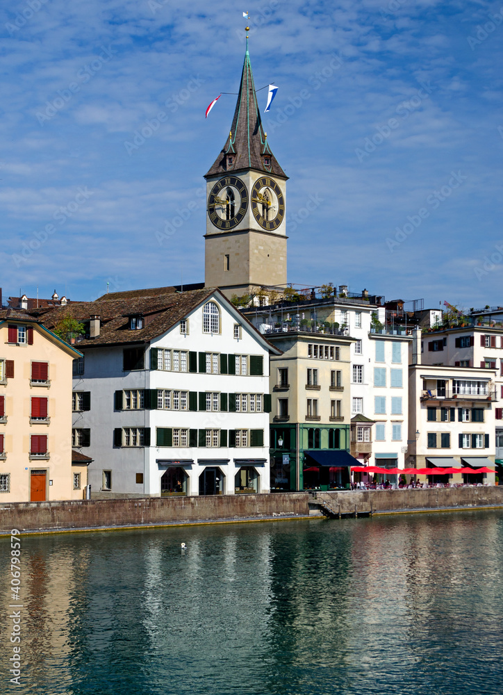 Zurich architecture along the Limmat river bank with St Peter's church spire and clock
