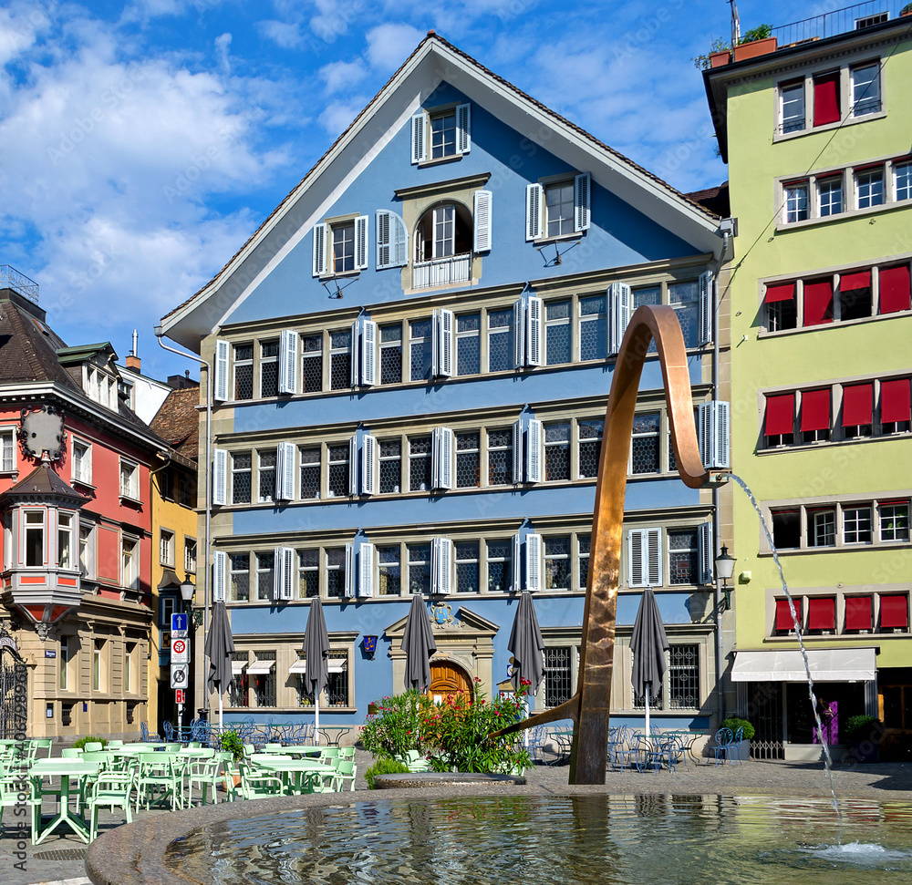 Fountain and colorful painted buildings in Munsterhof Square, Zurich, Switzerland