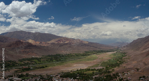 Idyllic landscape with beautiful sky. Panorama view of Humahuaca ravine, brown mountains, Andes desert, green valley and Tilcara village in Jujuy, Argentina.  © Gonzalo
