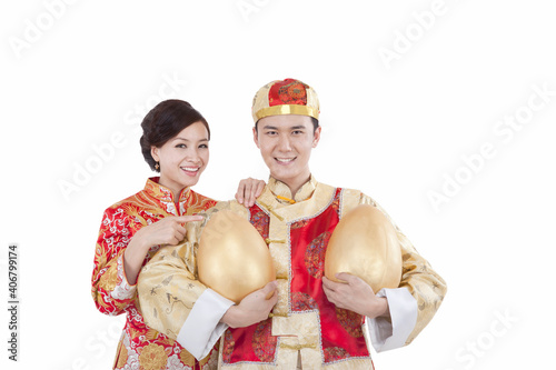 Portrait of young couple in Tang suits holding Jin Dans