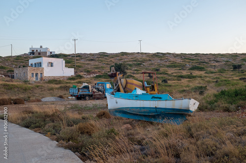 Arki, Dodecanese, Greece - August 12, 2019: Fishing boat neat the road photo