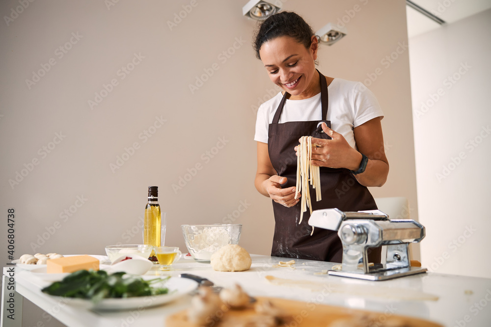 Happy lady enjoying the process of cooking at home Happy lady enjoying the process of cooking at home