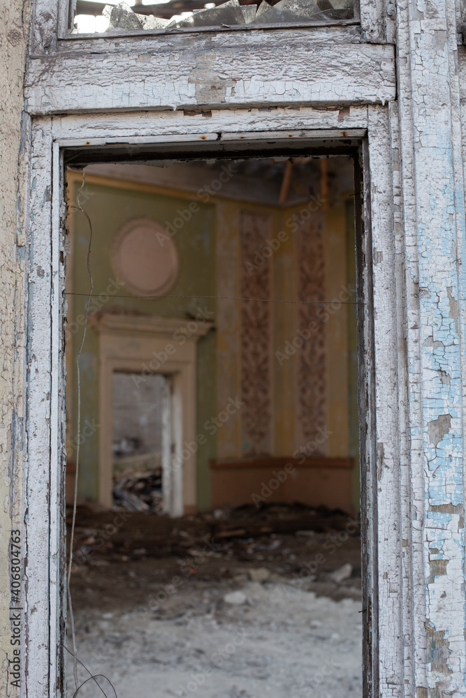 Old window frame with broken glass and peeling paint