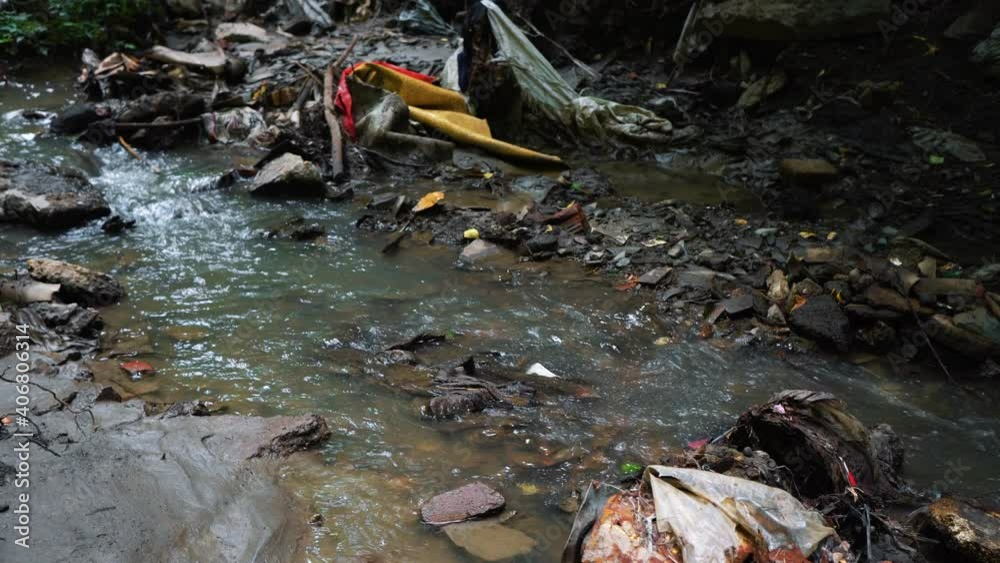 Garbage pile in a polluted forest. Dump plastic bottles, bags, cans. The concept of environmental pollution and environmental catastrophe.