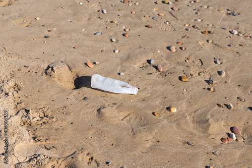 Plastic water bottle polluting the beach