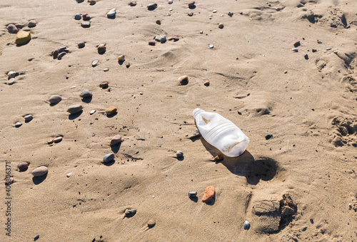 Plastic water bottle polluting the beach