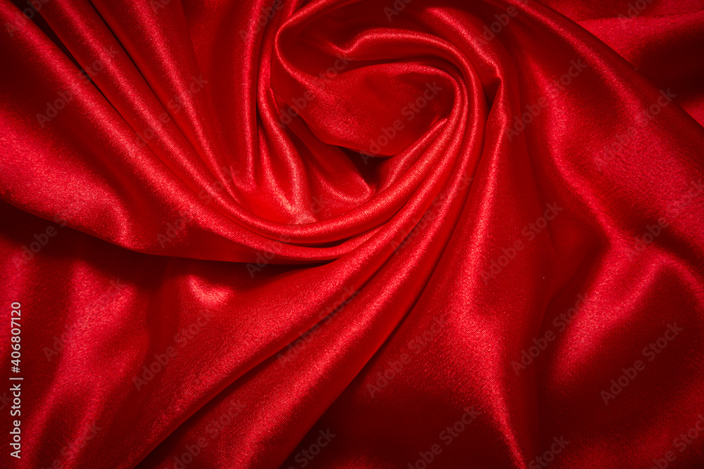 Obraz premium Luxury red satin smooth fabric background for celebration, ceremony, event invitation card or advertising poster