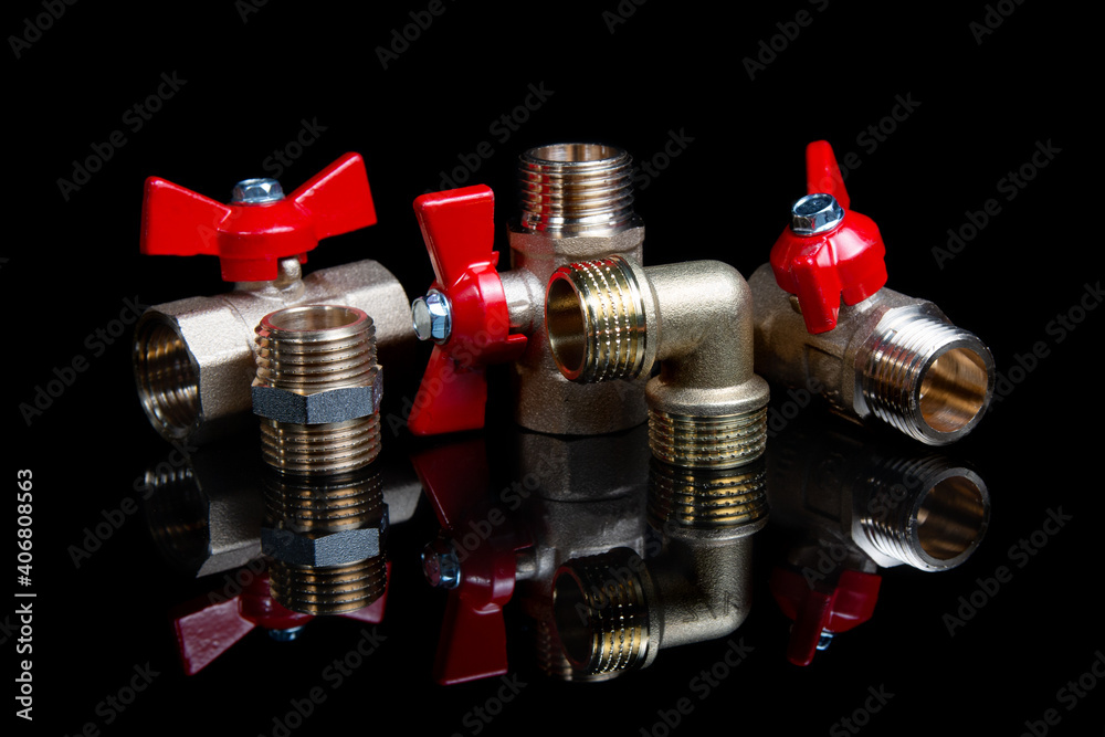 Plumbing gate ball vales and fiting on a black background Plumbing gate ball vales and fiting on a black background