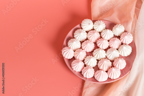 Sugar protein dessert in pastel colors in a pink plate on pink background. Copy Space