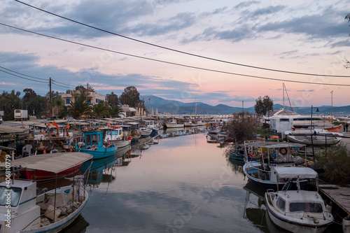 Tolo, Peloponesse, Greece - January 06, 2019: Fishing boats under the sunset