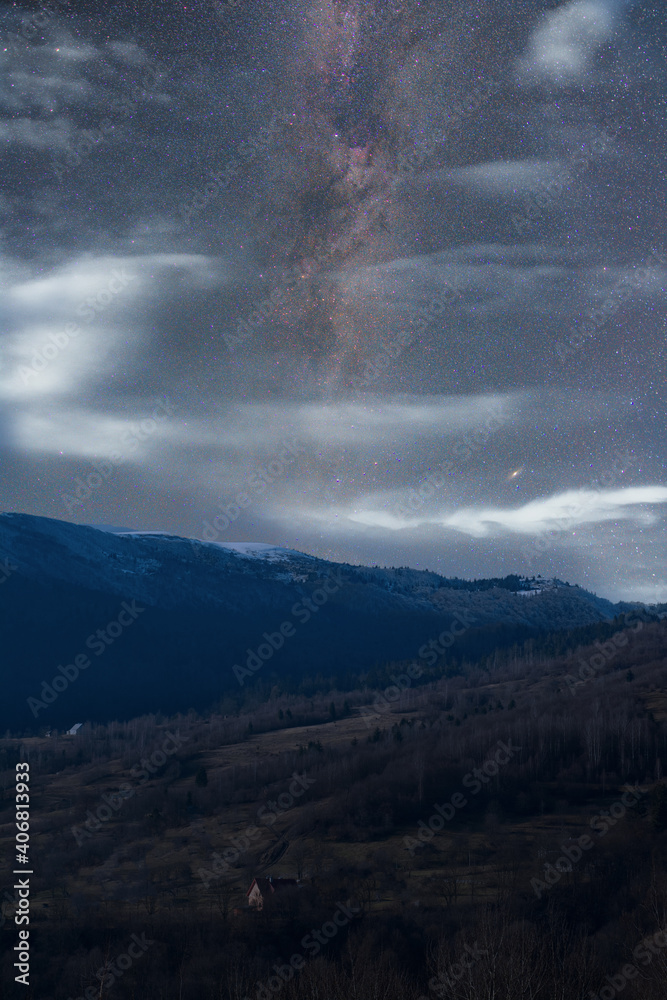 clouds and stars over the mountains
