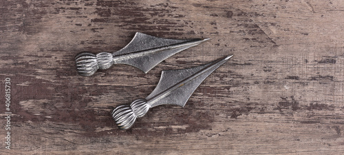 iron arrowheads on wooden background