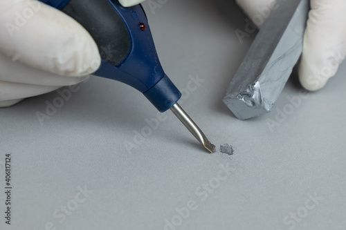 repairing chips and scratches on a wooden surface wax and soldering iron close-up,restoration photo