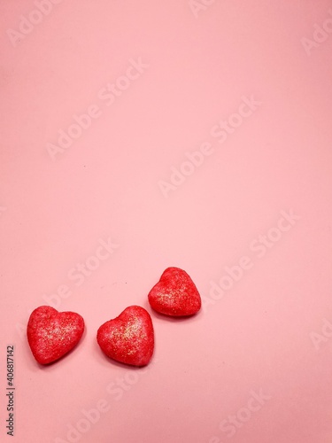 small red hearts on a soft pink colored background  copy space. Valentine s Day concept for design