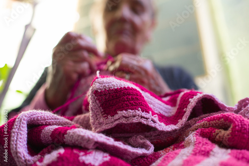 Senior Woman Knitting At Her Home