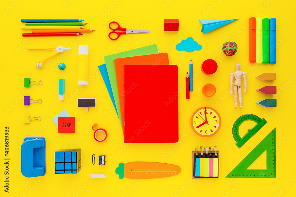 School accessories collection and blank notebook on yellow background. Top view. School accessories collection and blank notebook on yellow background. Top view.