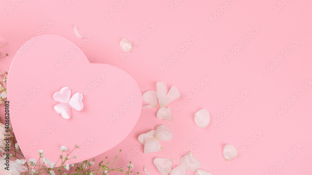 Pink heart shape gift box on a pink backround with small withe flowers, Celebration Valentine's day, holiday, anniversary of married couple, birthday background