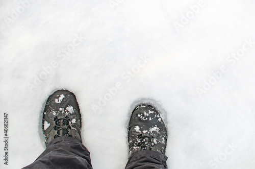Boots in the snow, close-up of hiking shoes from above