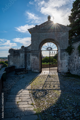 Entrance to the Sanctuary of the 7 Churches, with the reflection of the sun and the wonderful gate. Six chapels along the way up to the square of Villa Duodo, Padua, Veneto, Italy. photo