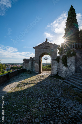 Entrance to the Sanctuary of the 7 Churches, with the reflection of the sun and the view over the city of Monselice. Six chapels along the way up to the square of Villa Duodo, Padua, Veneto, Italy.