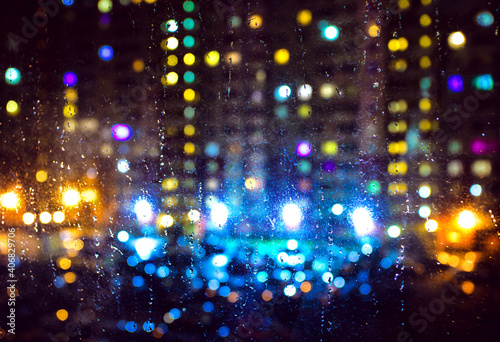 A view of blurred city lights through wet glass