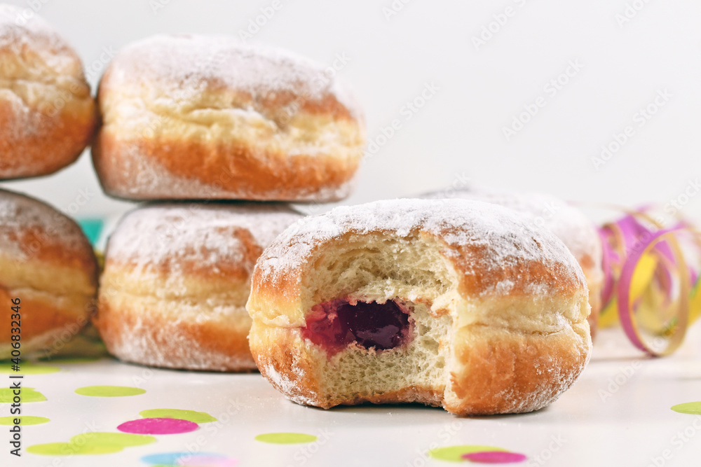 Jam filling inside a 'Berliner Pfannkuchen', a traditional German donut like dessert made from sweet yeast dough fried in fat. Traditional served during carnival.