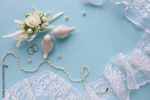 wedding card design in pastel colors. flowers, wedding ring and figurines of white birds. flat lay. congratulation. invitation