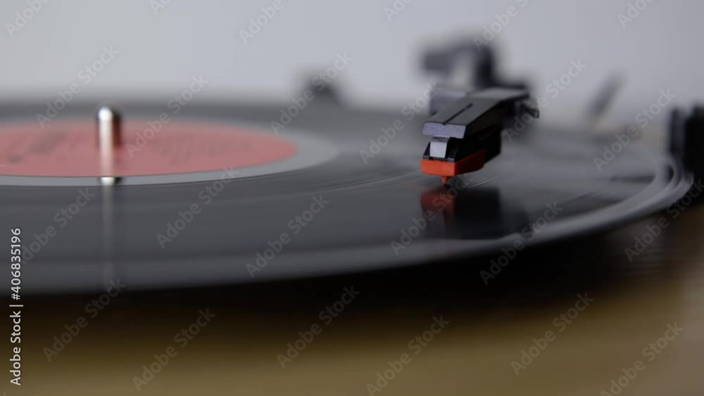 Vinyl Turntable Gramophone Record. Included gramophone and torque plate close-up on a light background. Hand puts and takes of LP needle on record. Includes authentic vinyl crackling sound Vinyl Turntable Gramophone Record. Included gramophone and torque plate close-up on a light background. Hand puts and takes of LP needle on record. Includes authentic vinyl crackling sound