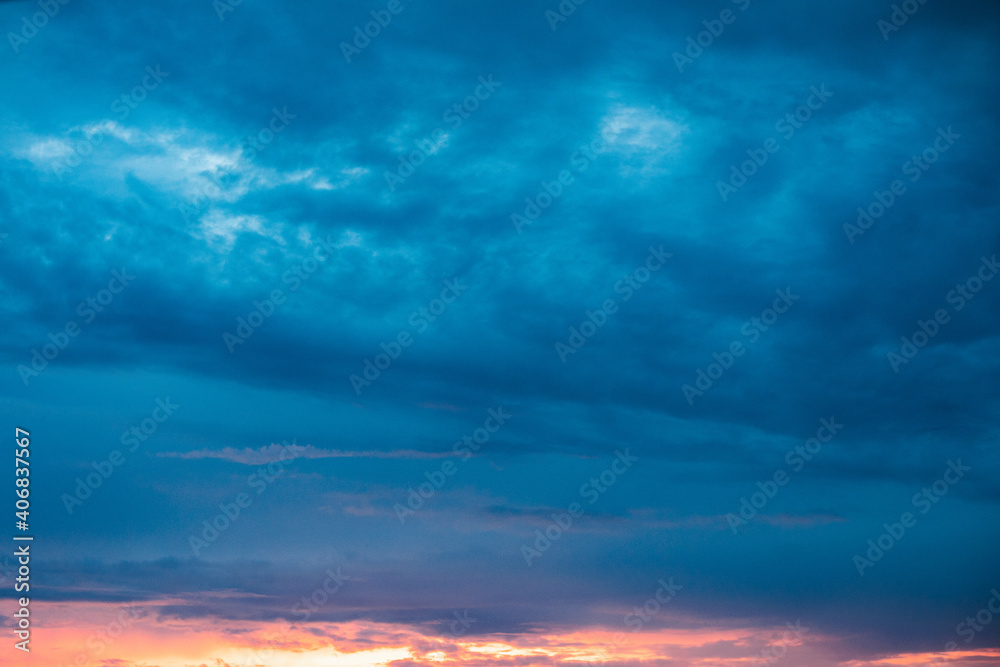 Very beautiful landscape of the evening sky with clouds, sunset. Blue, orange sky.