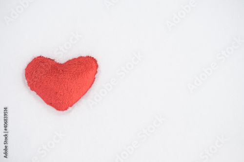 Tissue red heart lying in snow. love. valentine day
